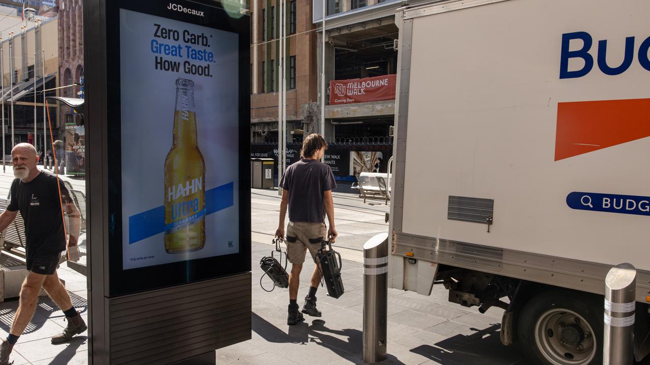 Workers are seen along Bourke Street, in Melbourne