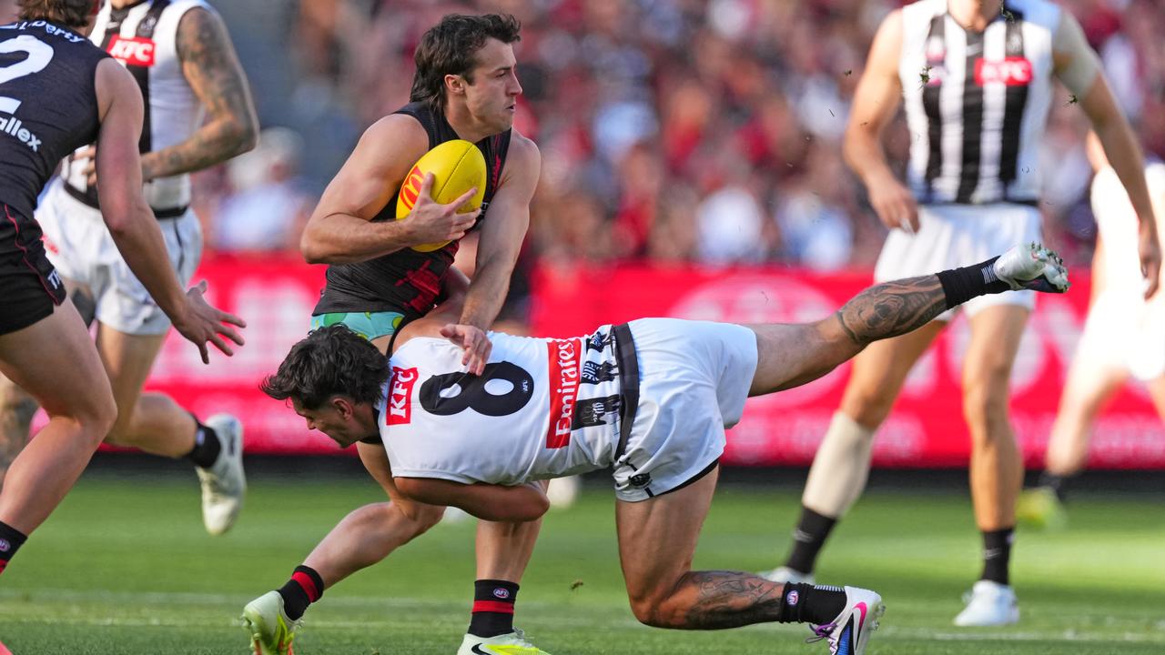 Andrew McGrath is tackled by Lachie Schultz.
