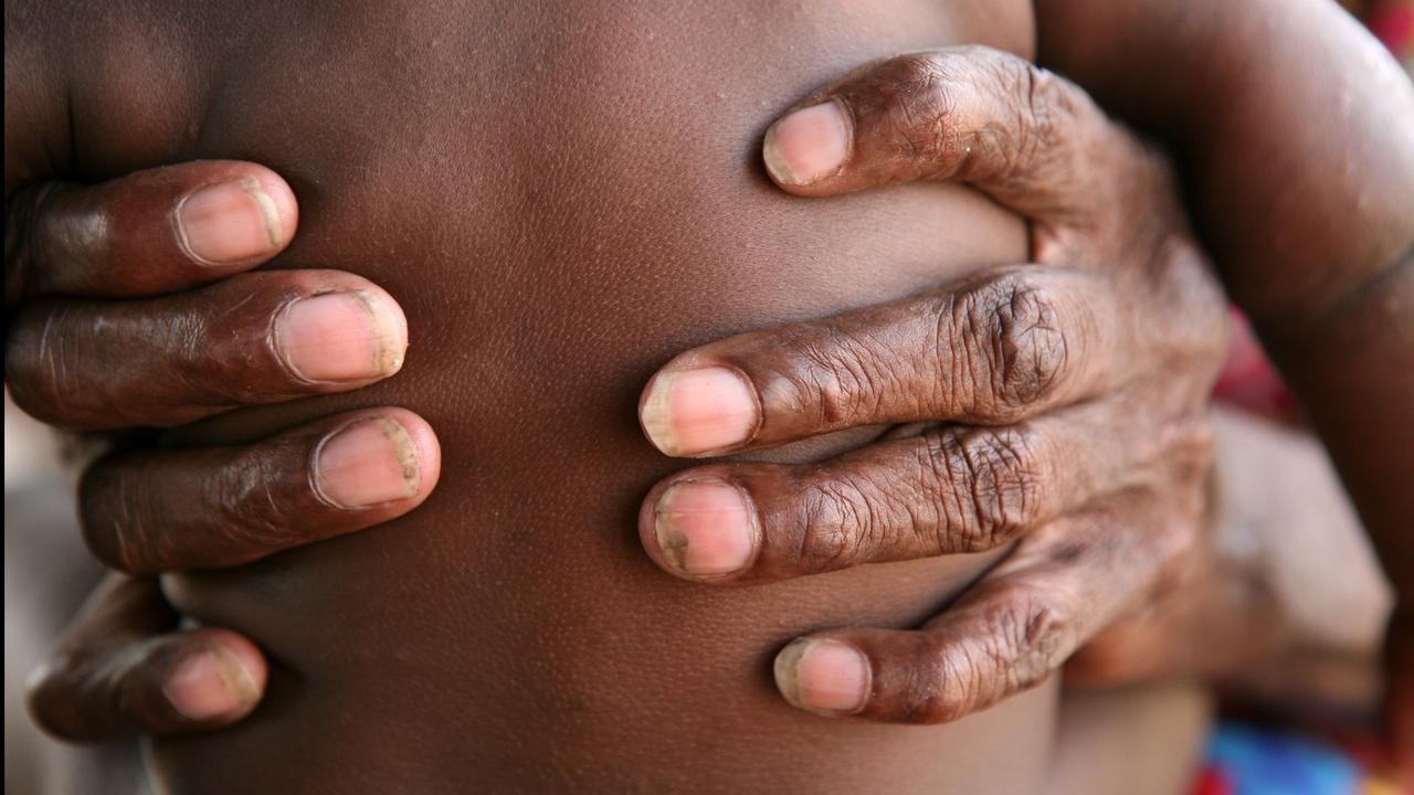 A grandmother holds her granddaughter in the Northern Territory
