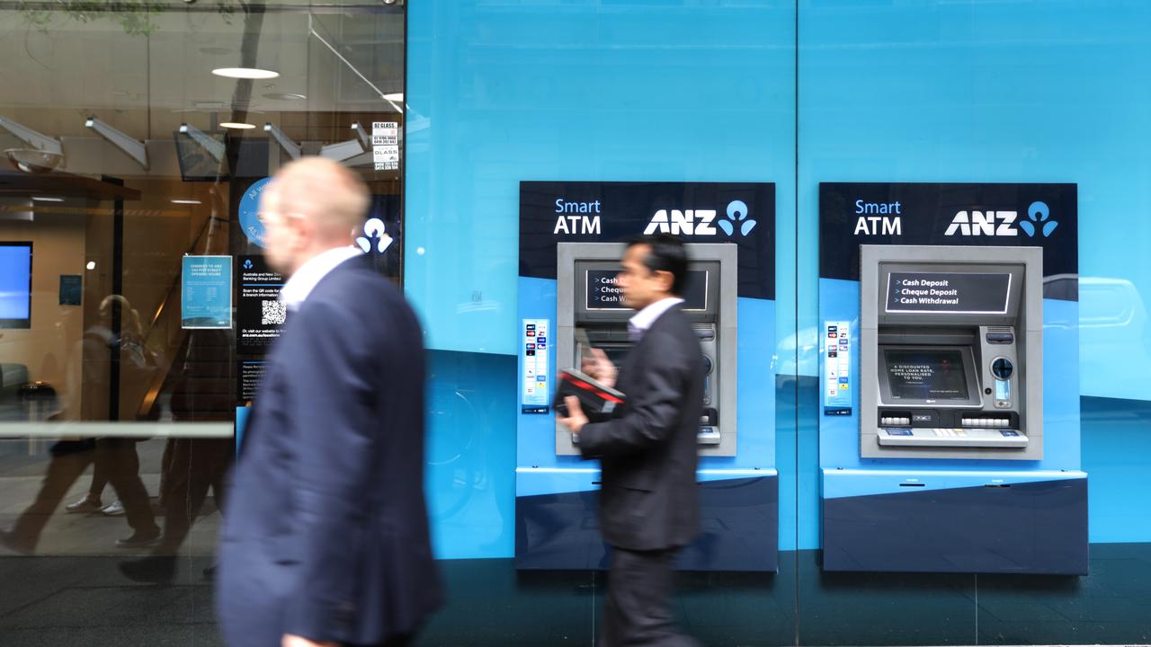 People walk past ANZ ATMs