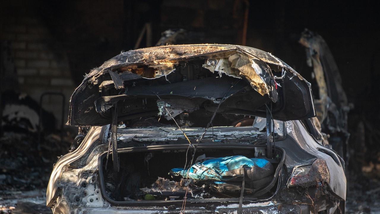 A burnt out car sits in the driveway of a Caulfield property