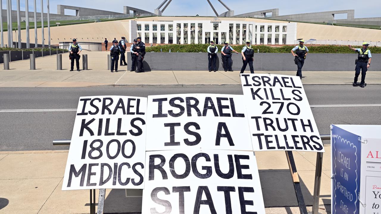 Police at a rally to protest the visit of Israel's President