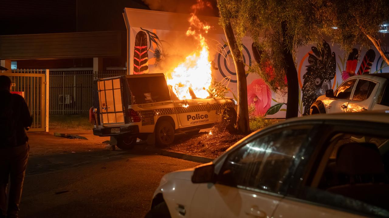 A police vehicle alight after community members clashed with police.