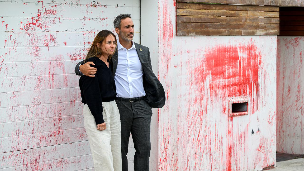 Alex Ryvchin and wife outside their home where cars were set alight