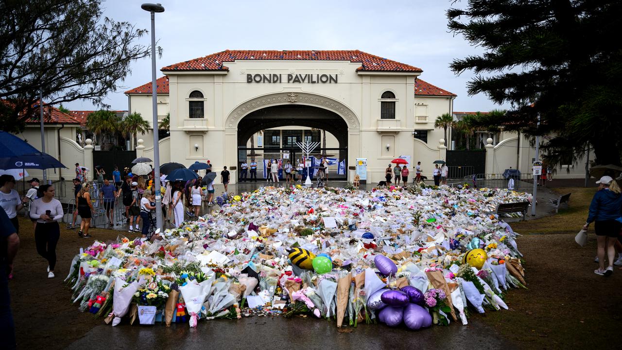 Mourners place flowers at a memorial at Bondi Beach