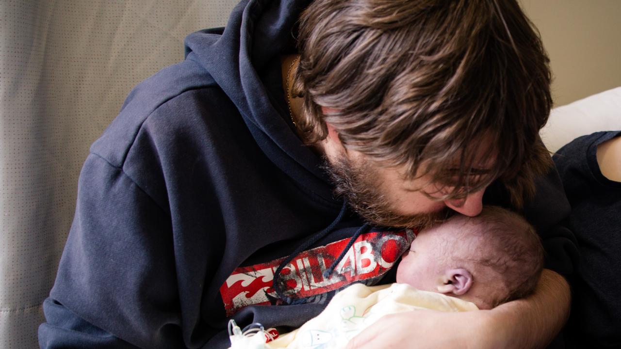 Benn Lockyer holding son James (file)