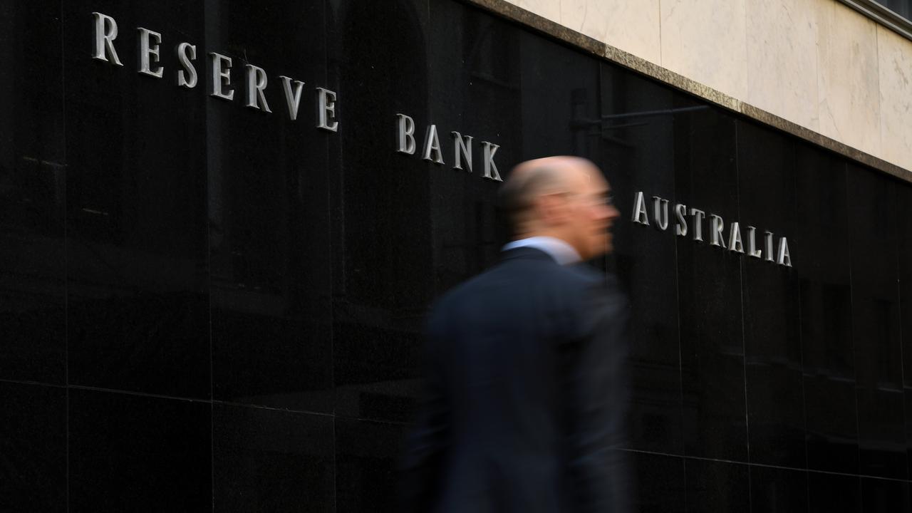 A man walks past the Reserve Bank of Australia  building in Sydney