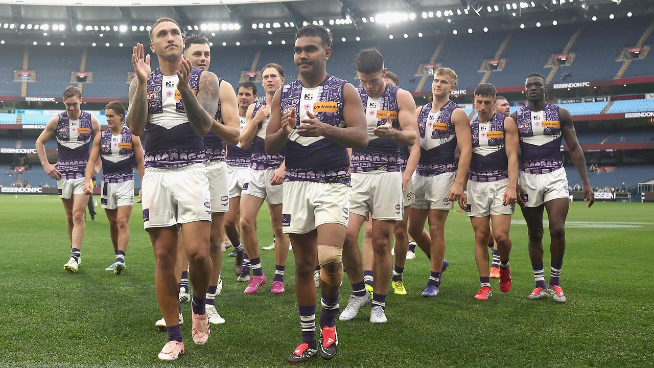 Fremantle players leave the MCG after notching a ninth straight win.